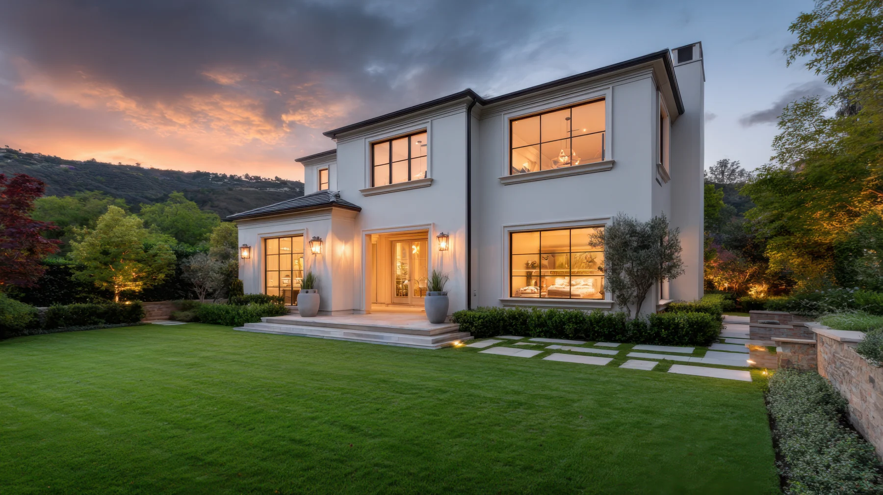 Modern home with landscaped grounds at blue hour